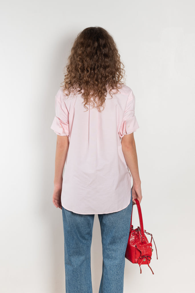 The Cuffed Sleeve Shirt by Acne Studios is a button-up shirt crafted from 100% organic cotton, featuring short tailored cuff sleeves