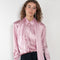 The Layered Satin Shirt by Acne Studios is a button-up shirt blouse crafted from lightweight, fluid satin fabric, featuring constructed scarf detailing