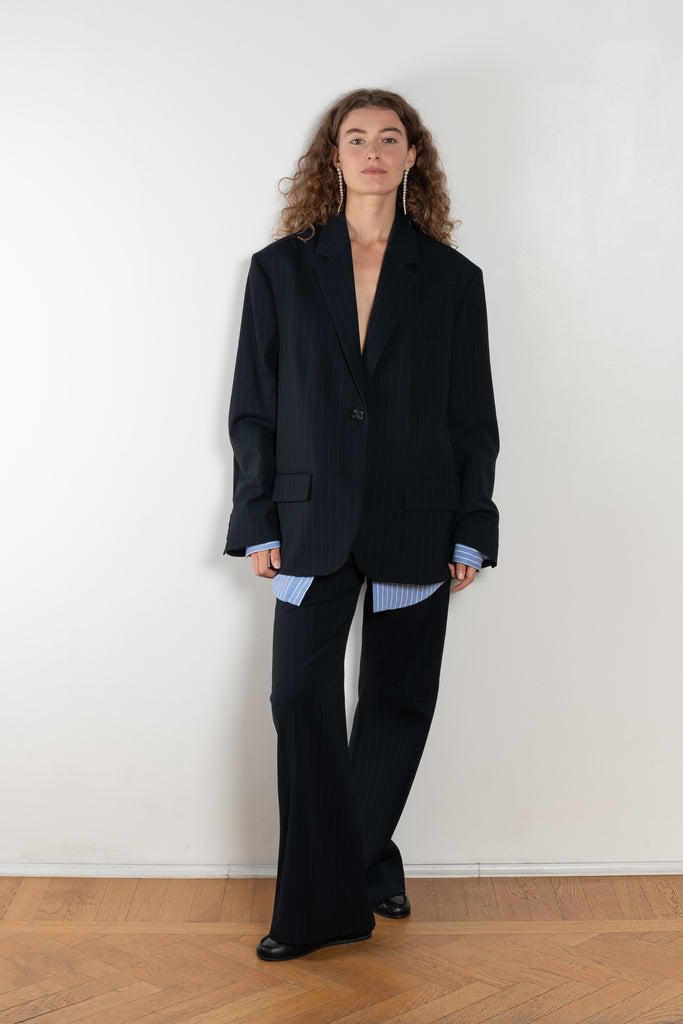 The Pinstripe Trouser by Acne Studios feature a pinstripe pattern crafted from a soft fluid fabric. Cut to a regular fit with a mid-waist, bootcut leg and extra long length.