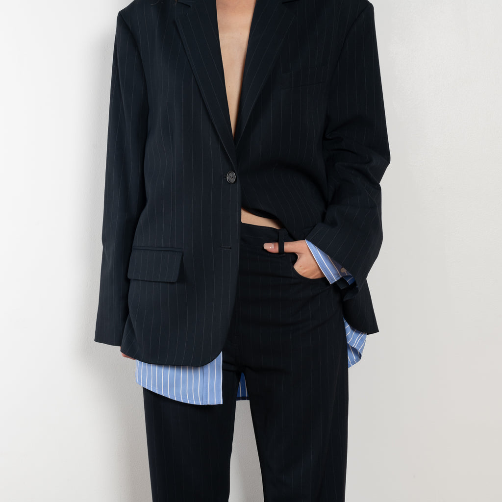 The Pinstripe Trouser by Acne Studios feature a pinstripe pattern crafted from a soft fluid fabric. Cut to a regular fit with a mid-waist, bootcut leg and extra long length.