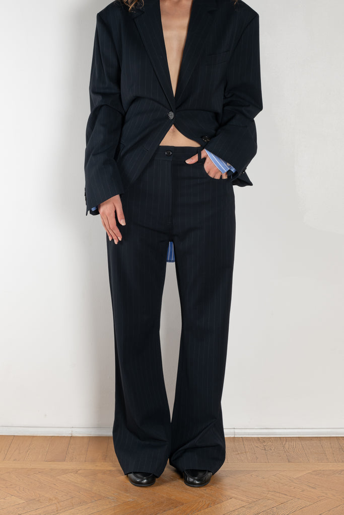 The Pinstripe Trouser by Acne Studios feature a pinstripe pattern crafted from a soft fluid fabric. Cut to a regular fit with a mid-waist, bootcut leg and extra long length.