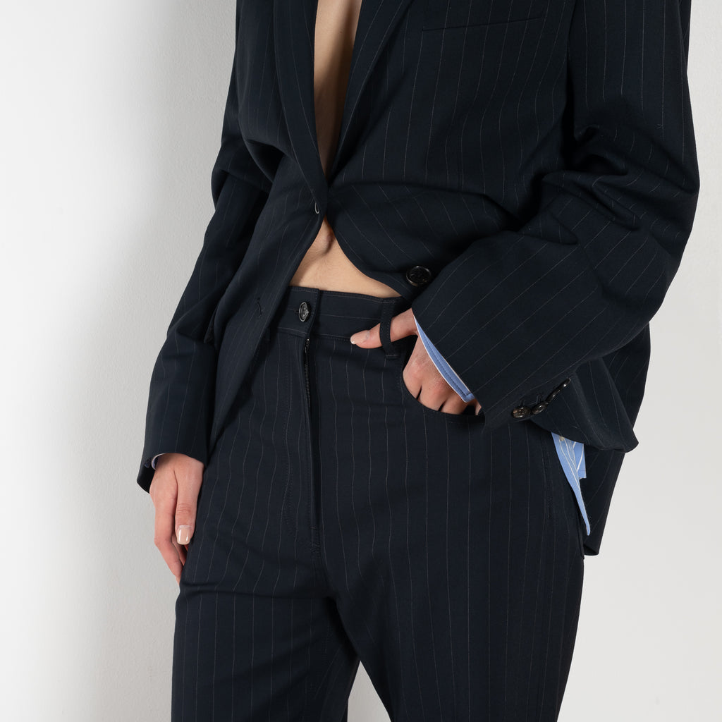 The Pinstripe Trouser by Acne Studios feature a pinstripe pattern crafted from a soft fluid fabric. Cut to a regular fit with a mid-waist, bootcut leg and extra long length.