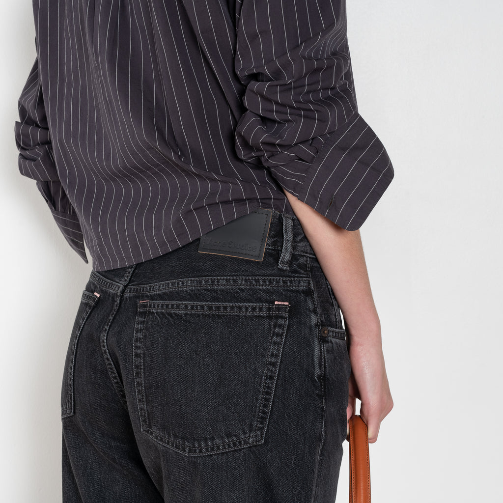 The 2021 Loose Fit Jeans by Acne Studios are cut to a loose fit with mid-waist, wide leg and long length