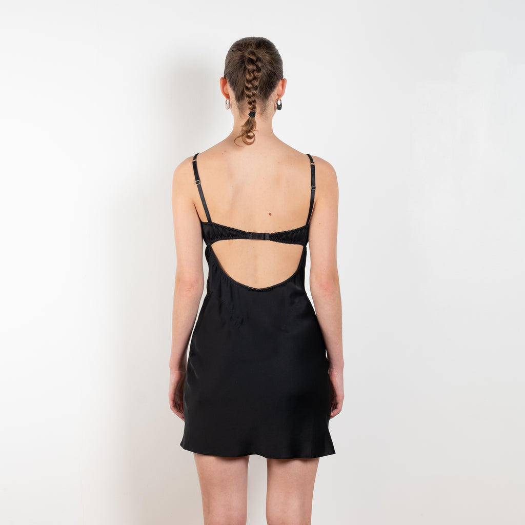 The Mini Waterlily Dress by Anna October is a signature lightweight summer dress with an open back and lingerie details