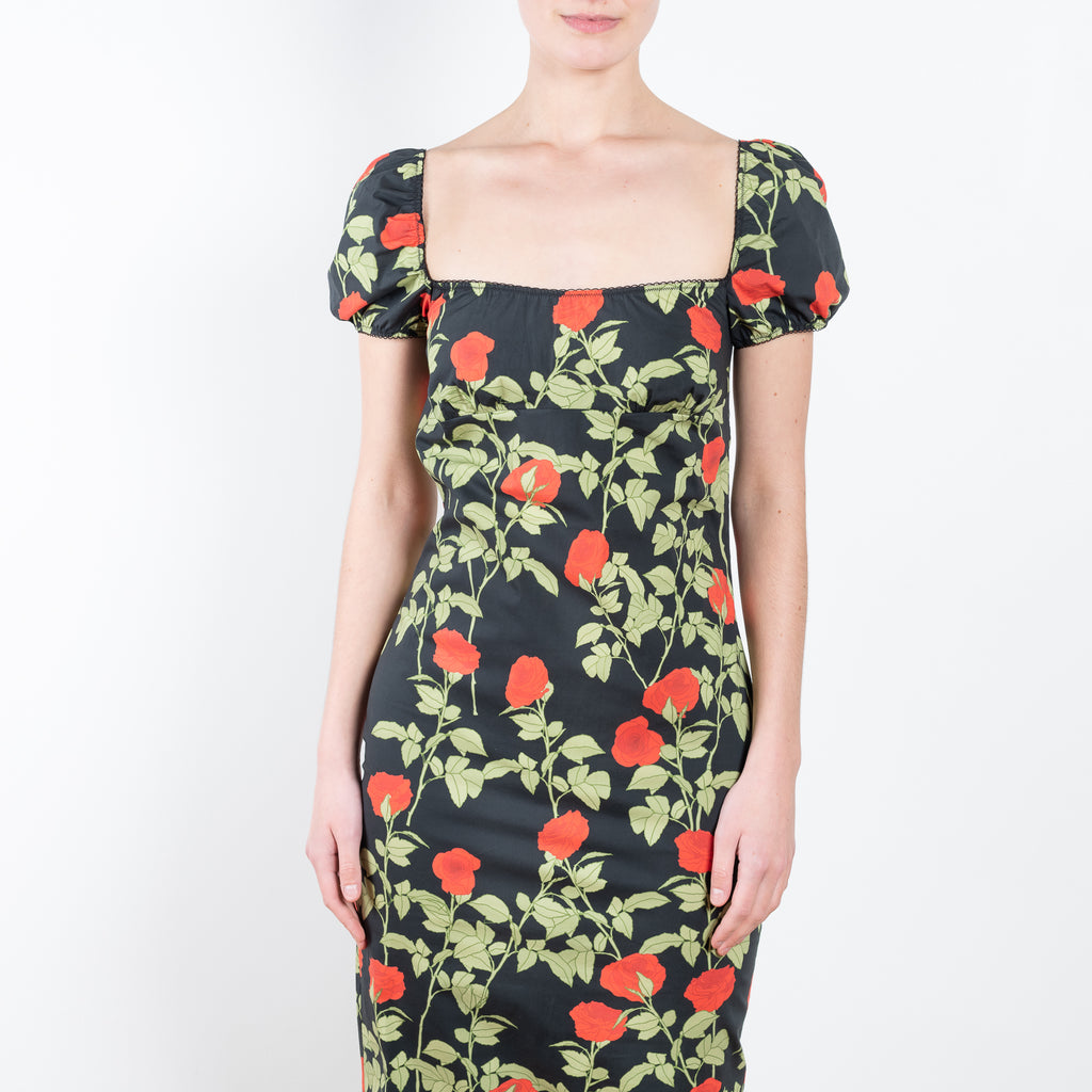 The Dress Rupert by Bernadette is a lightweight cotton summer dress with a fitted silhouette, cap sleeves and a lowered neckline