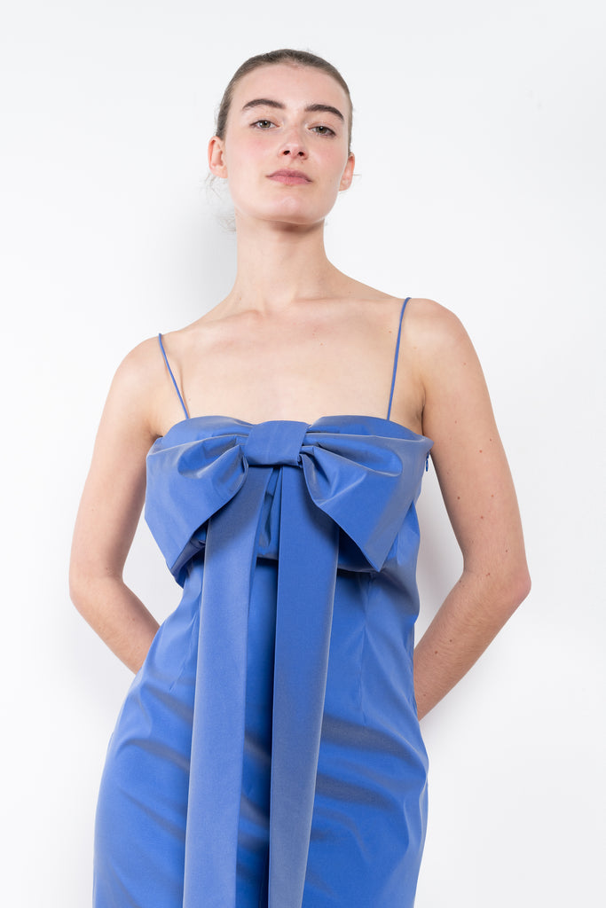 The Short Dress Estelle by Bernadette is a crisp taffeta  mini dress with a straight neckline, fine straps and an iconic bow in the middle