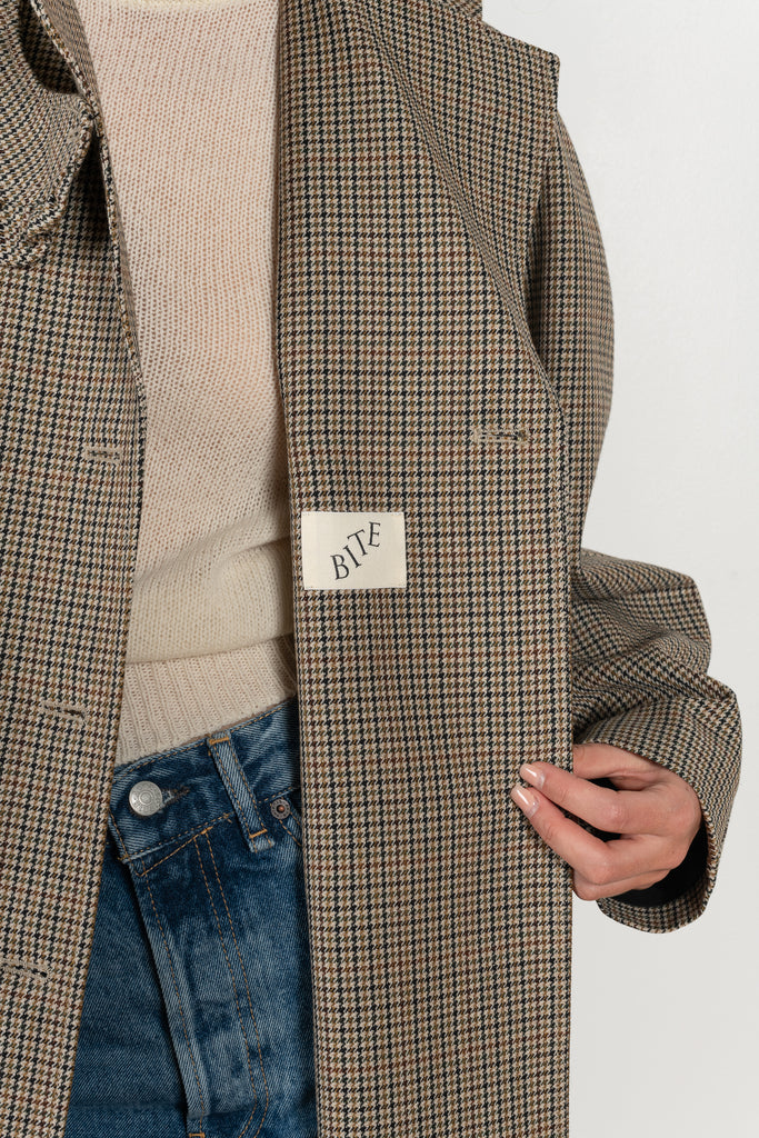 The Cordelia Coat by Bite is crafted from high-quality houndstooth check wool with a oversized silhouette