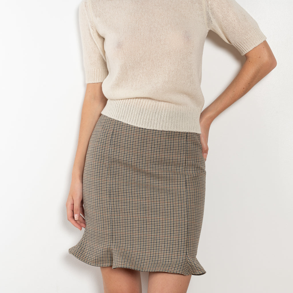 The Arista Flared Skirt by Bite is crafted from high-quality houndstooth check wool with a subtle fluted hem and an invisible side seam closure