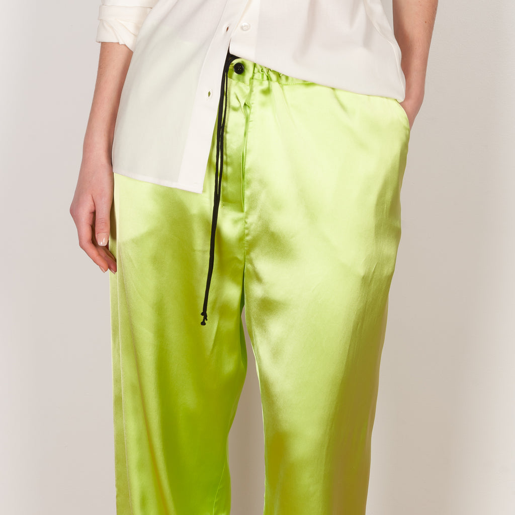 The Pyjama Trousers by Botter are relaxed silk drawstring trousers in a vibrant lime color