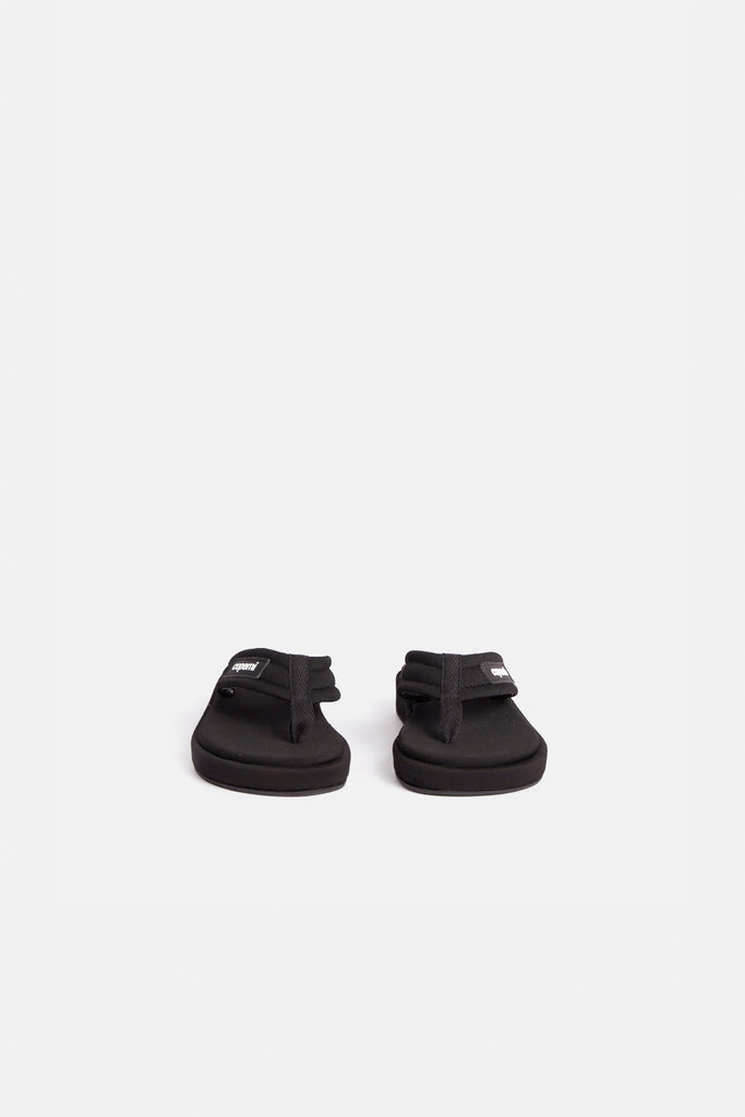The Branded Flip Flop by Coperni is a signature black sipper sandal covered with satin soles
