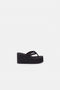 The Branded Wedge Sandal by Coperni is a signature black wedge sandal with lightweight platform soles
