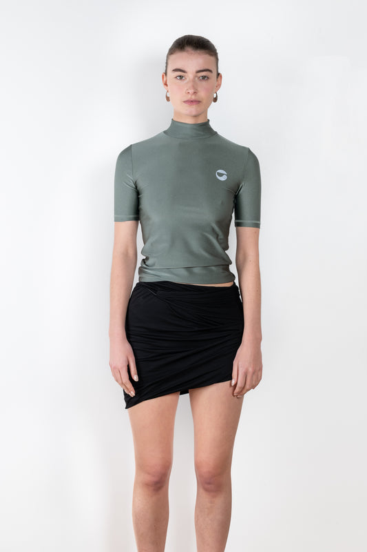 The High Neck Fitted Top by Coperni is a signature fitted top in subtle metallic sage green with a silver C Logo on the chest