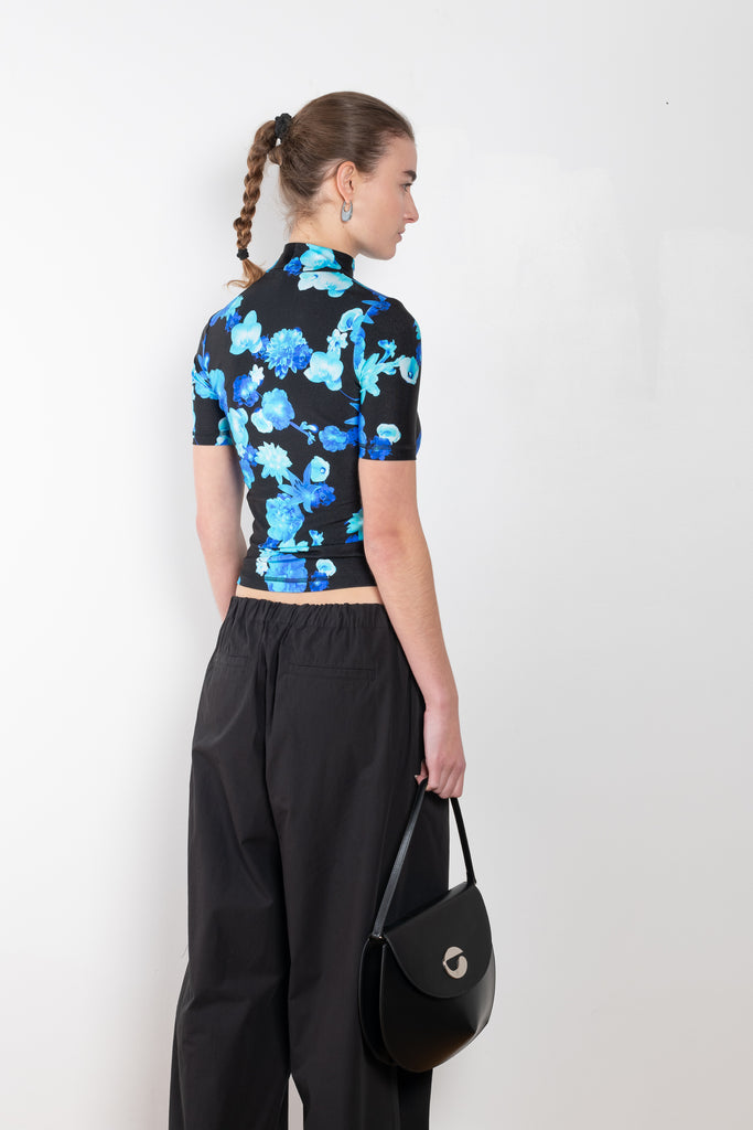 The High Neck Fitted Top by Coperni is a signature fitted top in a blue floral print with a silver C Logo on the chest