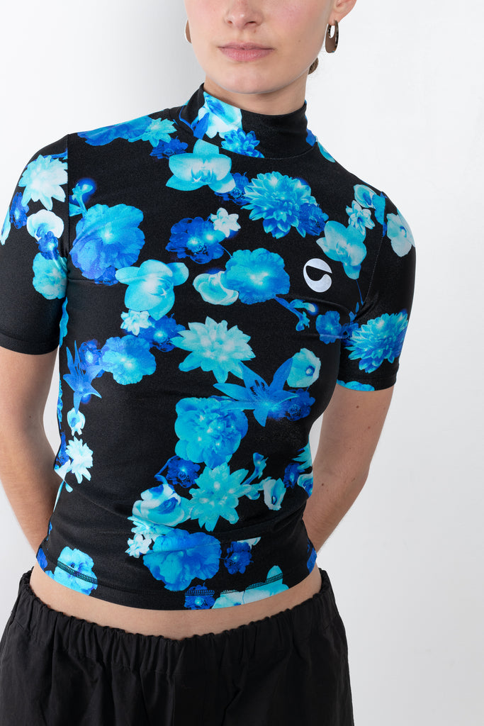 The High Neck Fitted Top by Coperni is a signature fitted top in a blue floral print with a silver C Logo on the chest