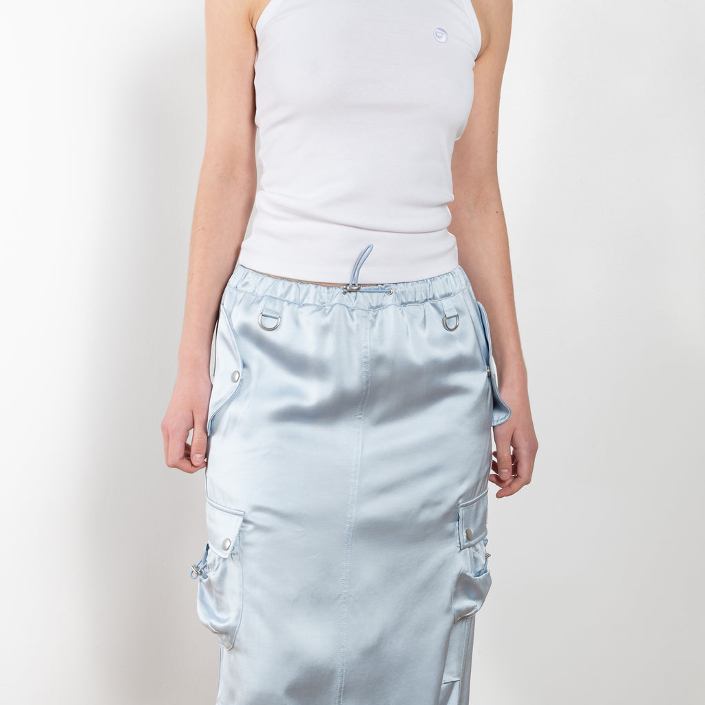 The Satin Cargo Skirt by Coperni is a signature maxi skirt with cargo details and an adjustable waistband to carry high or low slung according to your likings