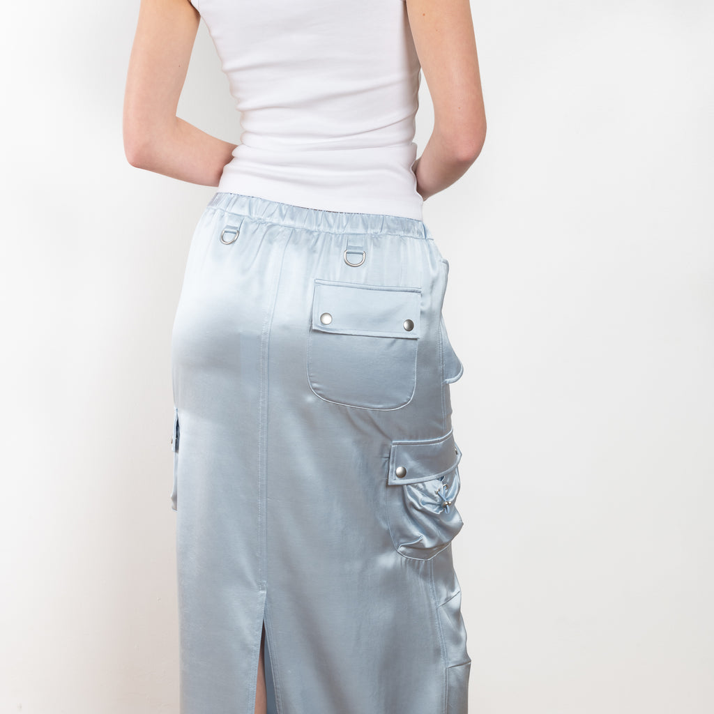 The Satin Cargo Skirt by Coperni is a signature maxi skirt with cargo details and an adjustable waistband to carry high or low slung according to your likings
