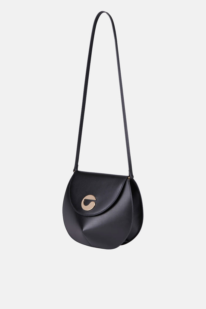 The U.F.O. Bag by Coperni is a signature smooth black leather shoulder bag with an angular shape and a silver tone C logo hardware
