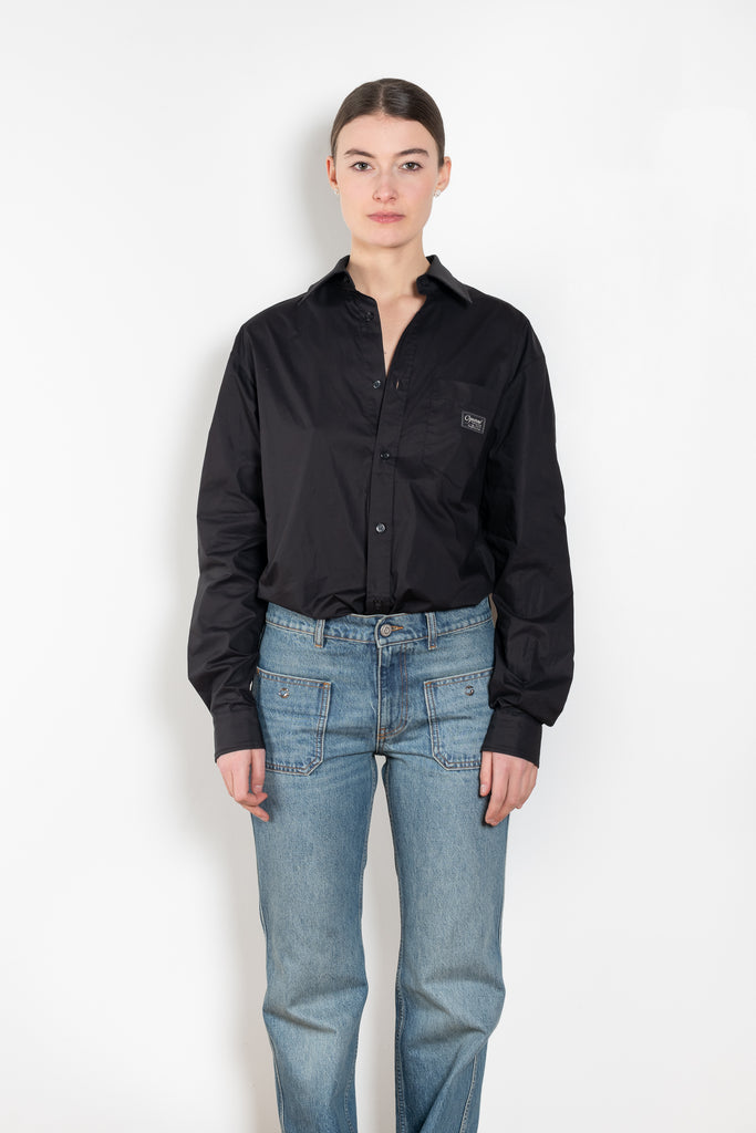 The Body Poplin Shirt by Coperni is a crisp cotton shirt with logo patch and body details
