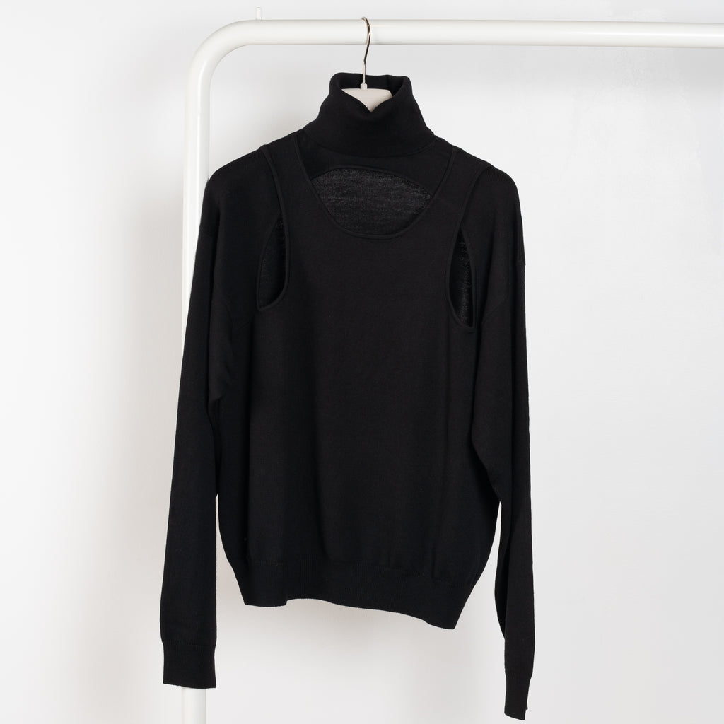 The Cut Out Loose Jumper by Coperni is a loose fitted sweater with a cut outs on the chest