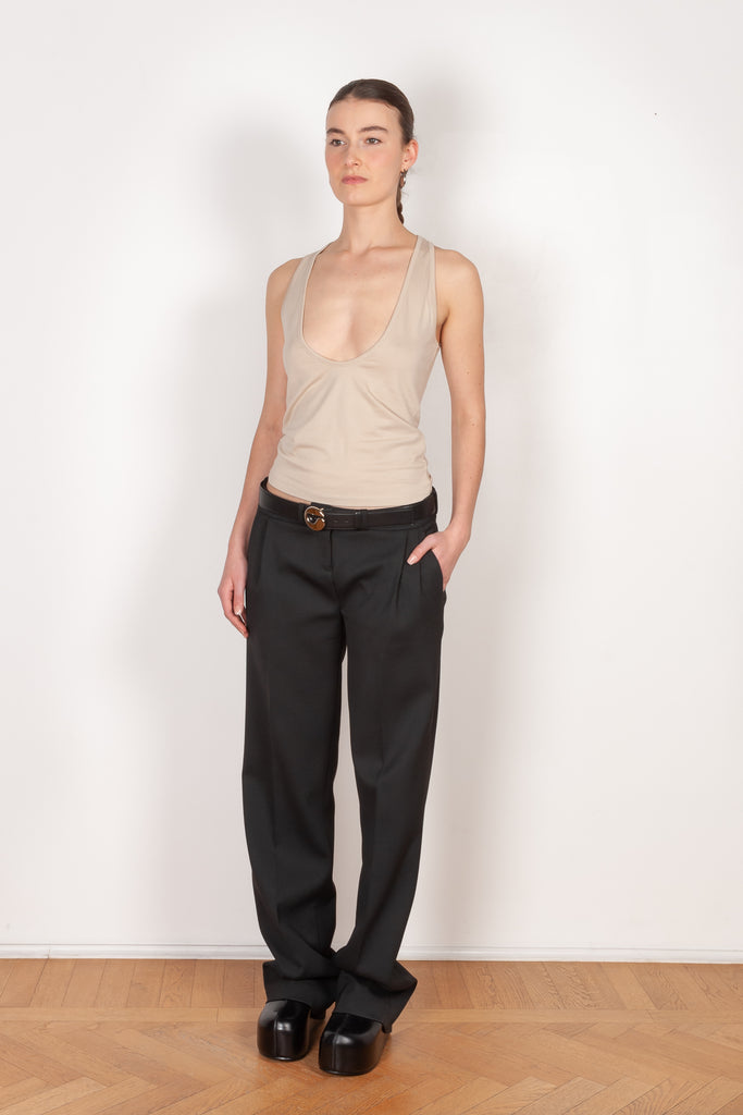 The Deep Cut Tank Top by Coperni is a fitted tank top with a deep cut at the front