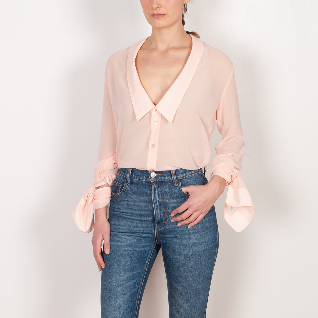 The Open Collar Shirt by Coperni is a crepe shirt with a deep collar and long sleeves meant to be tied up
