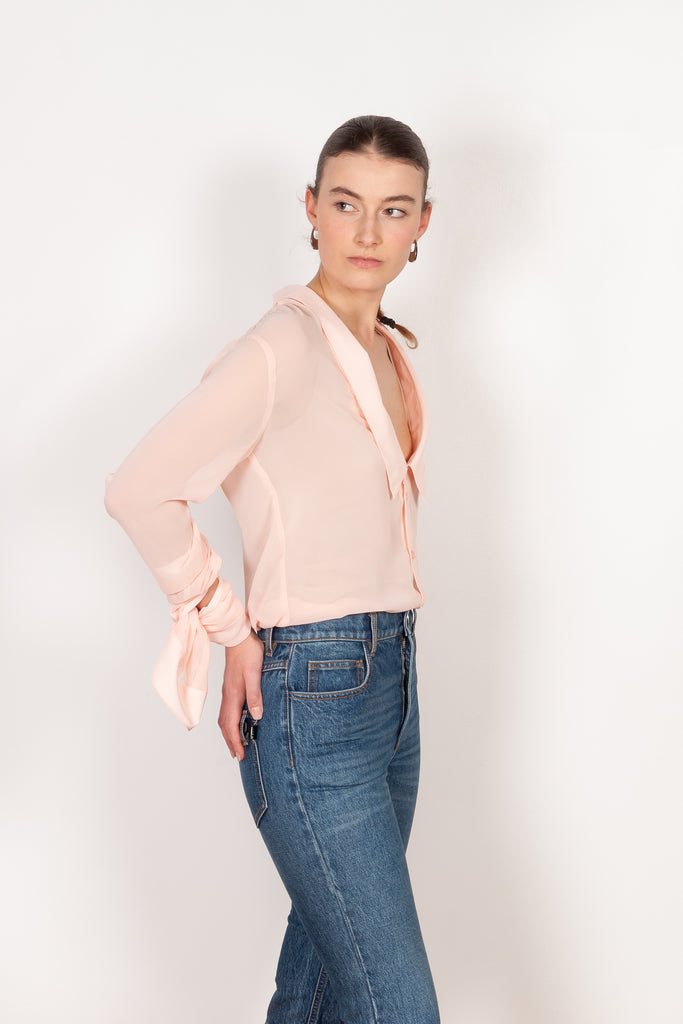 The Open Collar Shirt by Coperni is a crepe shirt with a deep collar and long sleeves meant to be tied up