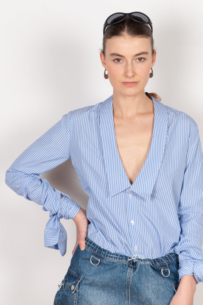 The Striped Open Collar Shirt by Coperni is a crisp cotton shirt with long sleeves meant to be tied up