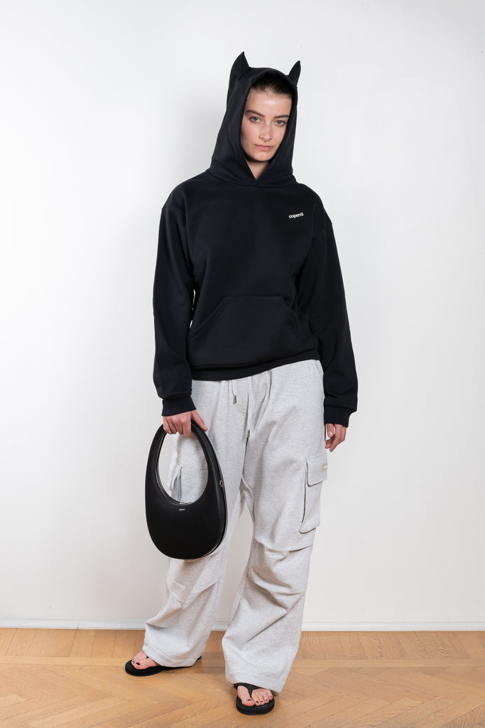 The Horn Hoodie by Coperni is a signature hooded sweater with two fabric constructed horns for a playfull twist and a small logo on the chest