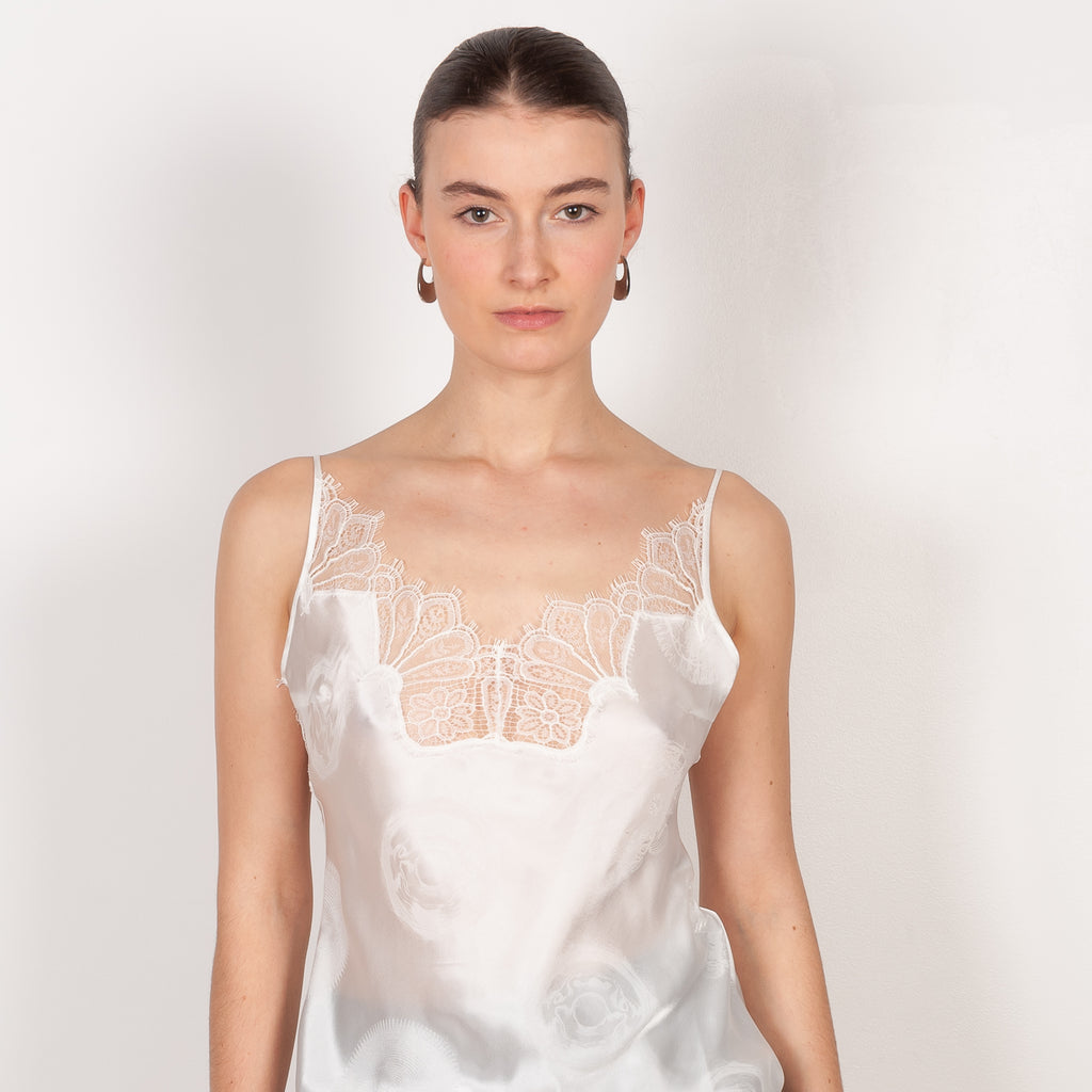 The Jacquard Cymatic Top by Coperni is a lingerie inspired silk top with a delicate scalloped lace neckline