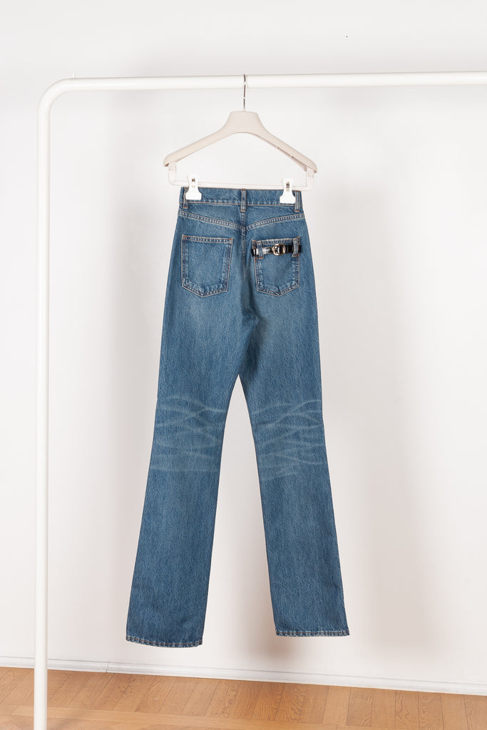 The Straight Denim Pants by Coperni is a straight legged jeans with a high waist and a belted detail on the back pocket