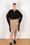 The Suede Skirt by Coperni is a beige suede leather skirt with a contrasted black patent detail