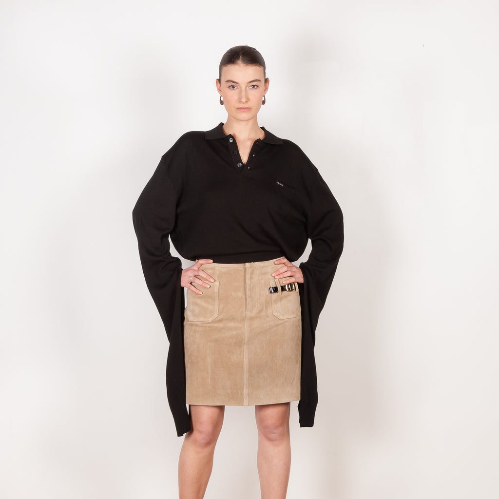The Suede Skirt by Coperni is a beige suede leather skirt with a contrasted black patent detail