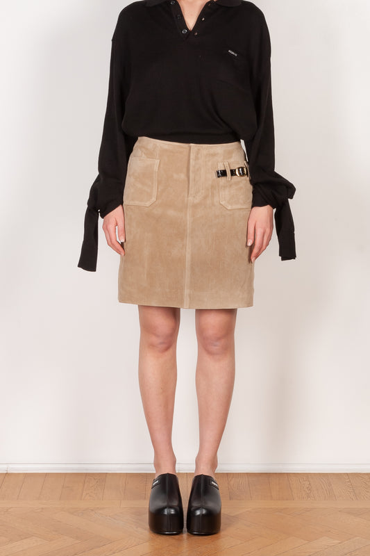 The Suede Skirt by Coperni is a beige suede leather skirt with a contrasted black patent detail