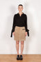 The Suede Skirt by Coperni is a beige suede leather skirt with a contrasted black patent detail