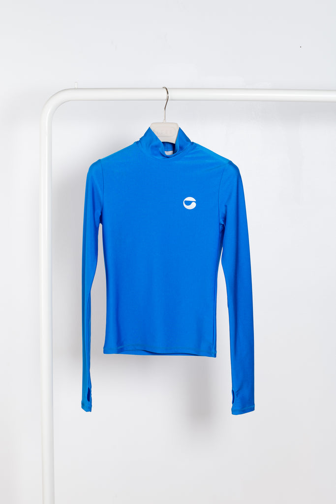The Tight High Neck Top by Coperni is a signature fitted top in electric metallic blue with a silver C Logo on the chest and thumb holes