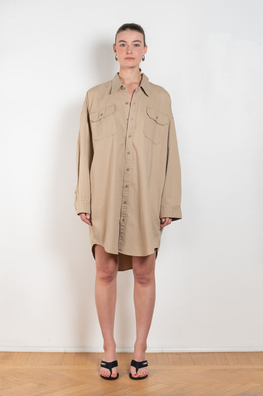 The Utility Shirtdress by Denimist is a relaxed oversized shirtdress with front pockets in a beige khaki cotton 