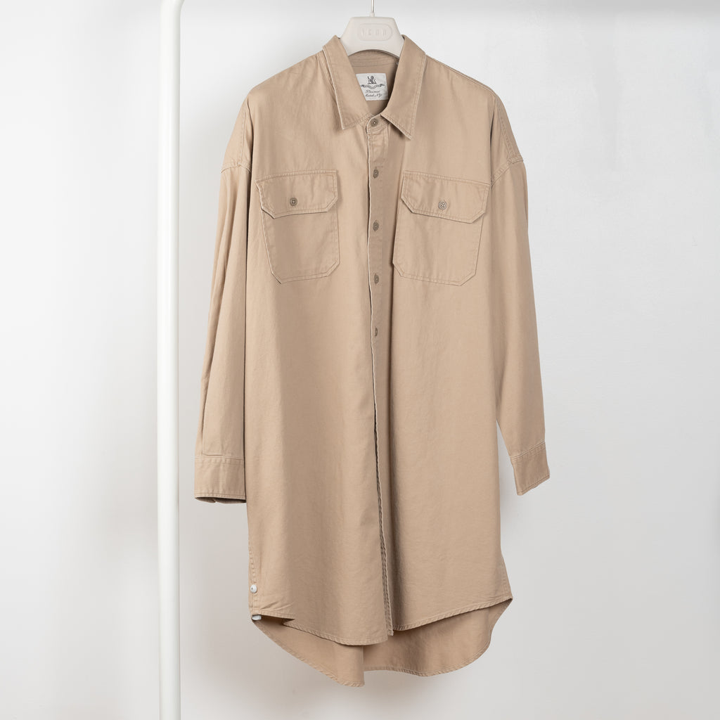 The Utility Shirtdress by Denimist is a relaxed oversized shirtdress with front pockets in a beige khaki cotton&nbsp;