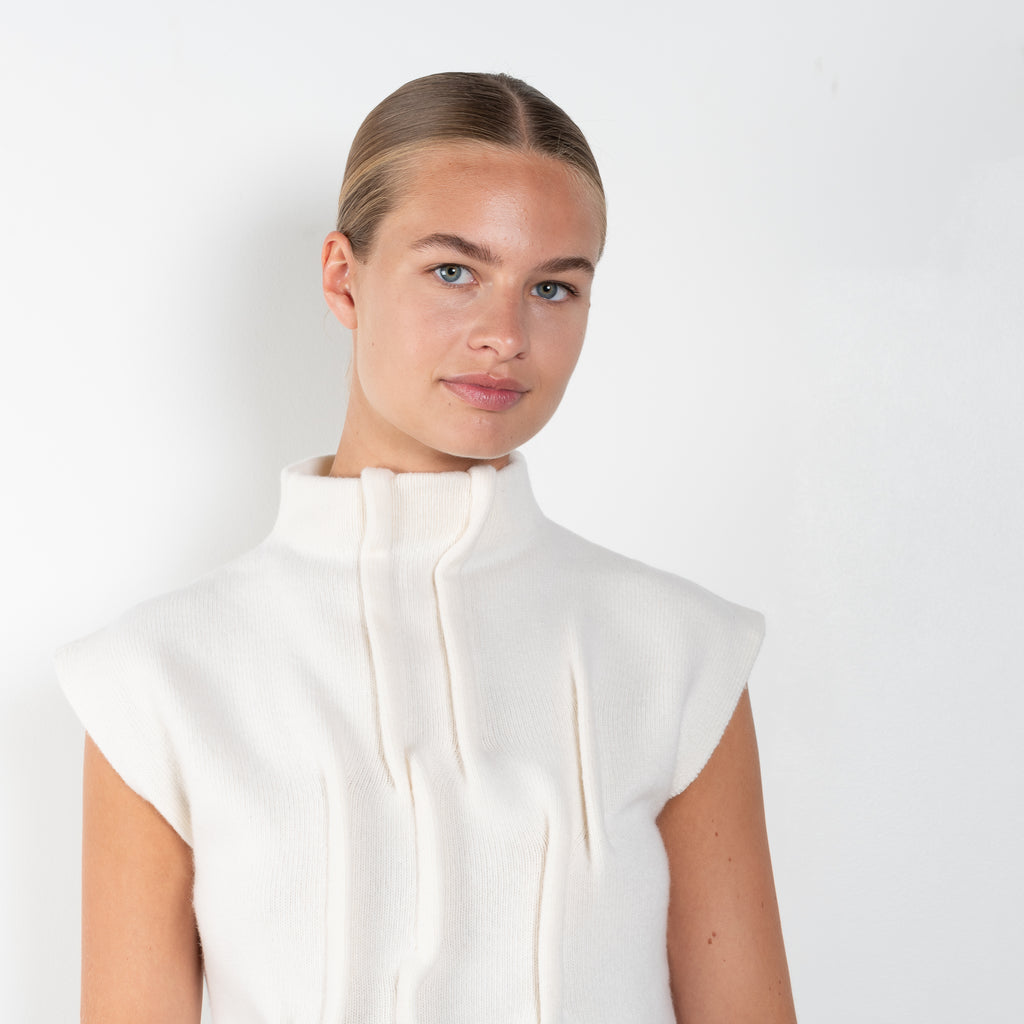 The Knit Top by Gauchere is a sleeveless high neck top with stitched details adding structure