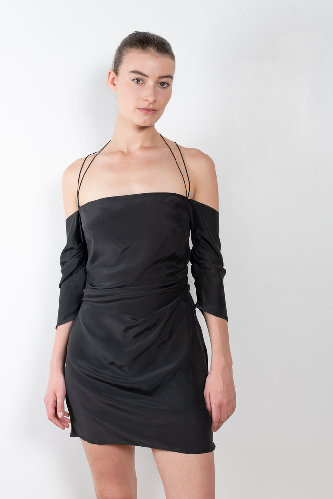 The Samaca Mini Dress by GAUGE81 is a silk off-the-shoulder dress with fine straps both as a halter & crossed back