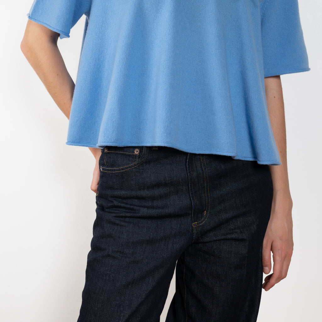 The Liru Tshirt by LISA YANG is knitted in 12-gauge cashmere. The relaxed fit falls from a ribbed round neck into a wide A-line, peplum-inspired shape