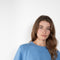 The Liru Tshirt by LISA YANG is knitted in 12-gauge cashmere. The relaxed fit falls from a ribbed round neck into a wide A-line, peplum-inspired shape