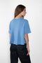 The Liru Tshirt by LISA YANG is knitted in 12-gauge cashmere. The relaxed fit falls from a ribbed round neck into a wide A-line, peplum-inspired shape
