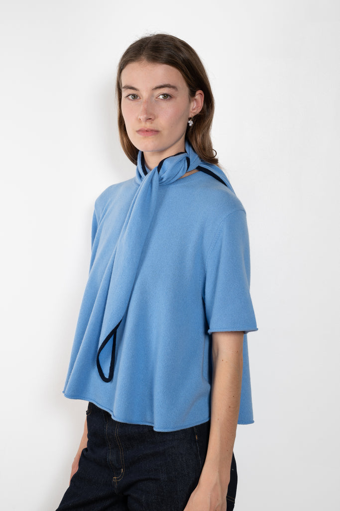 The Liru Tshirt by LISA YANG is knitted in 12-gauge cashmere. The relaxed fit falls from a ribbed round neck into a wide A-line, peplum-inspired shape