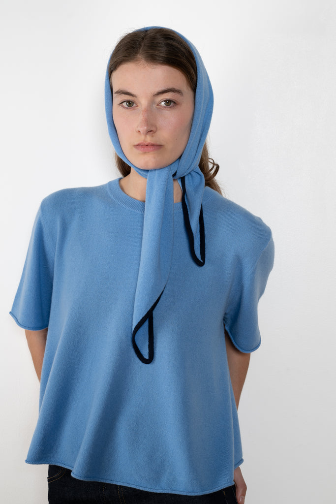 The Liru Tshirt by LISA YANG is knitted in 12-gauge cashmere. The relaxed fit falls from a ribbed round neck into a wide A-line, peplum-inspired shape