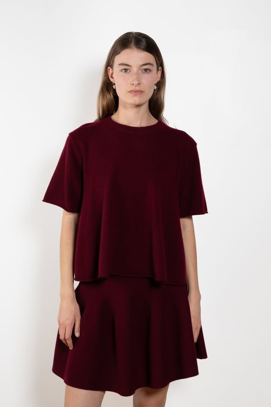 The Liru Tshirt by LISA YANG is knitted in 12-gauge cashmere. The relaxed fit falls from a ribbed round neck into a wide A-line, peplum-inspired shape, complete with dropped shoulders, short sleeves and rolled hems