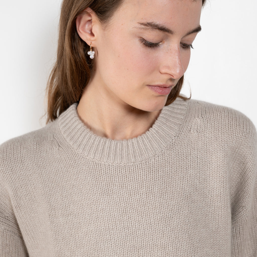 The Noor Sweater by Lisa Yang features a ribbed neck, dropped shoulders, oversized profile.