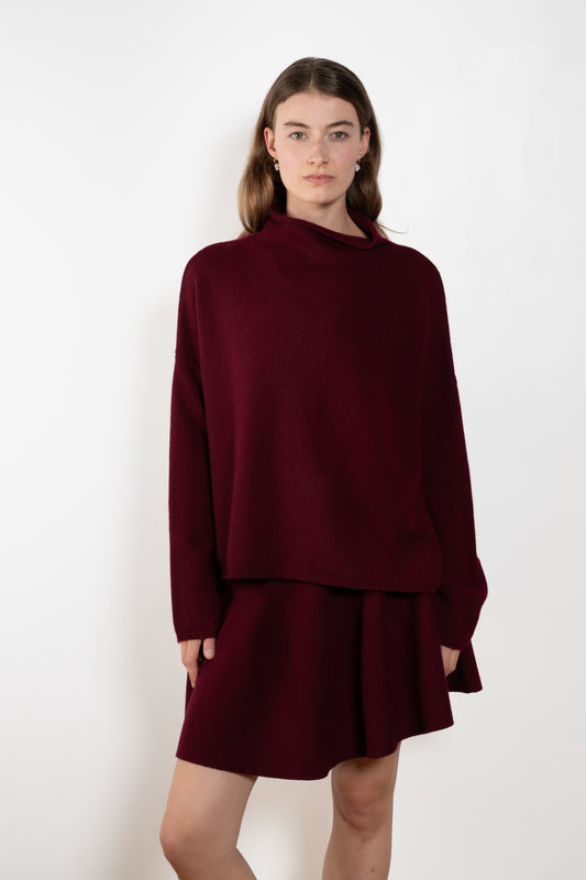 The Sandy Sweater by Lisa Yang has a straight fit with dropped shoulders and a raw hem mock neck.