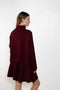 The Sandy Sweater by Lisa Yang has a straight fit with dropped shoulders and a raw hem mock neck.
