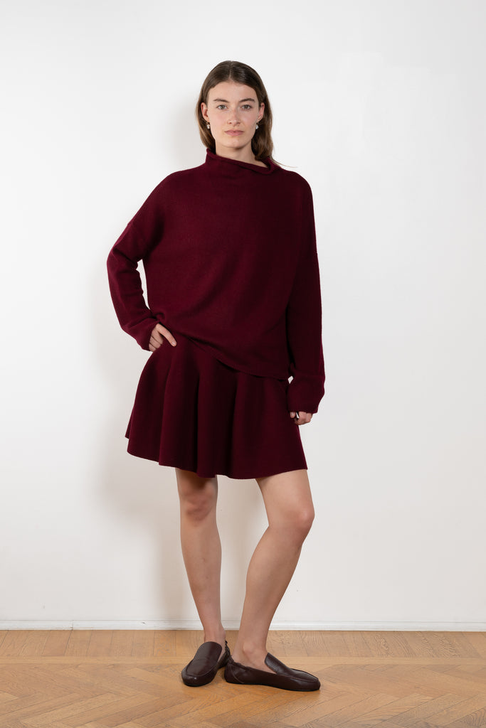 The Sandy Sweater by Lisa Yang has a straight fit with dropped shoulders and a raw hem mock neck.