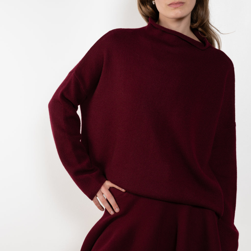 The Sandy Sweater by Lisa Yang has a straight fit with dropped shoulders and a raw hem mock neck.
